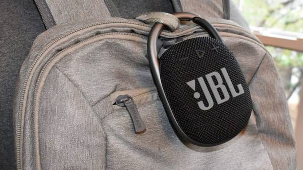 JBL Clip 4 speaker attached to a backpack.