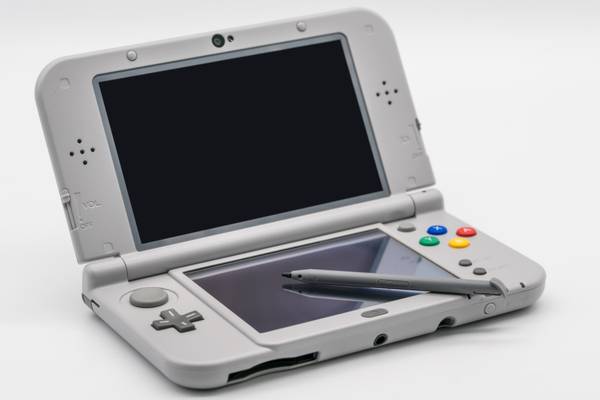 A Nintendo 3DS LL Super Famicom edition in gray complete with stylus.