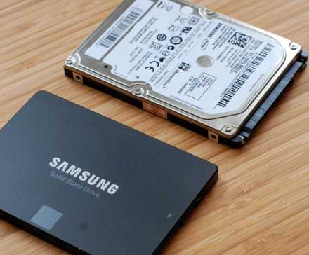A SSD next to a small mechanical hard drive.