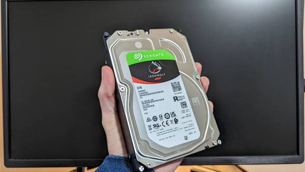 A Seagate Ironwolf hard drive being held.