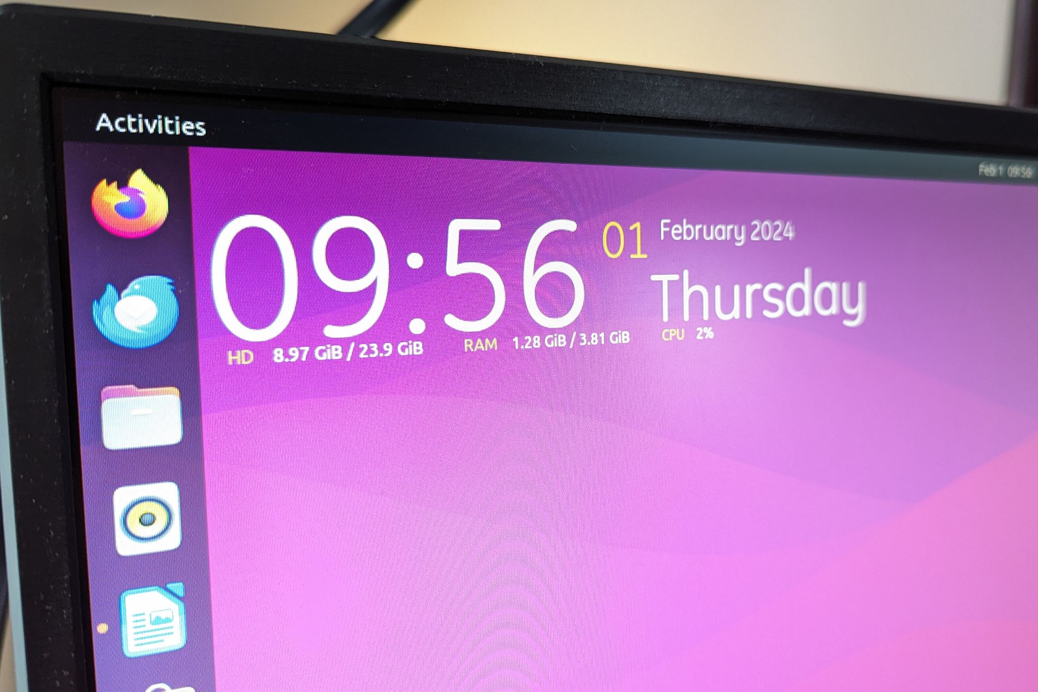 Top-left corner of an Ubuntu desktop with a Conky widget featuring date and time along with system stats.