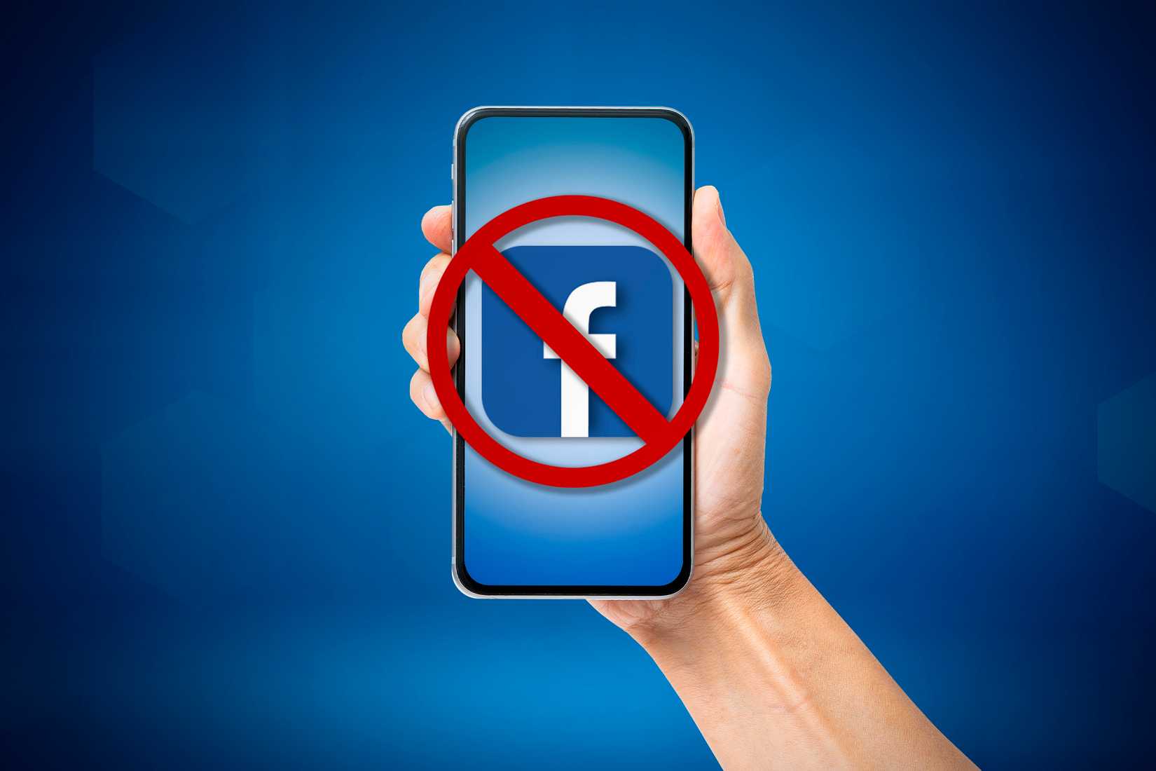 A person holding a smartphone with the facebook logo and a blocked symbol on the screen.