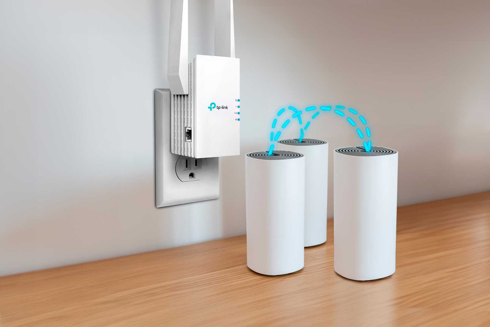 A Wi-Fi Extender on the wall and three Mesh routers above the desk.