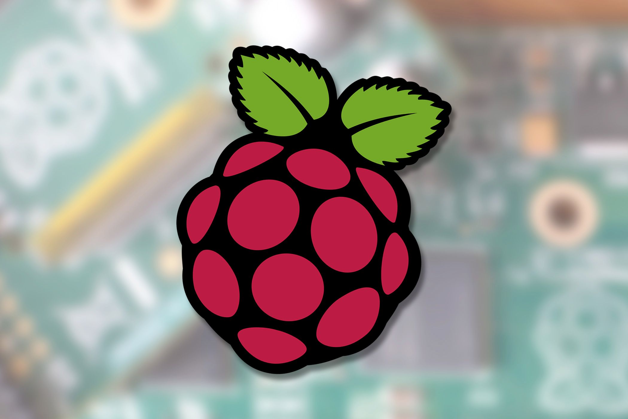 Raspberry Pi logo on top of a photo of Raspberry Pi boards.