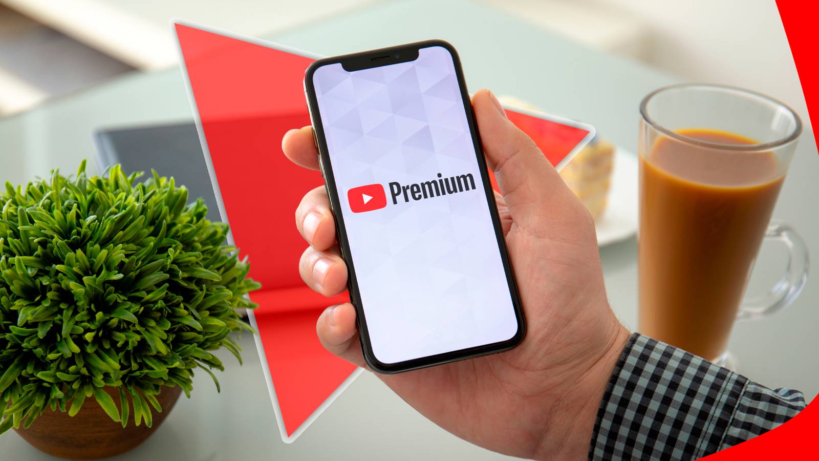 A hand holding a phone with Youtube Premium logo on the screen.