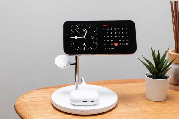 The Anker MagGo Wireless Charging Station (3-in-1 Stand) charging an iPhone in landscape standby mode and Airpods