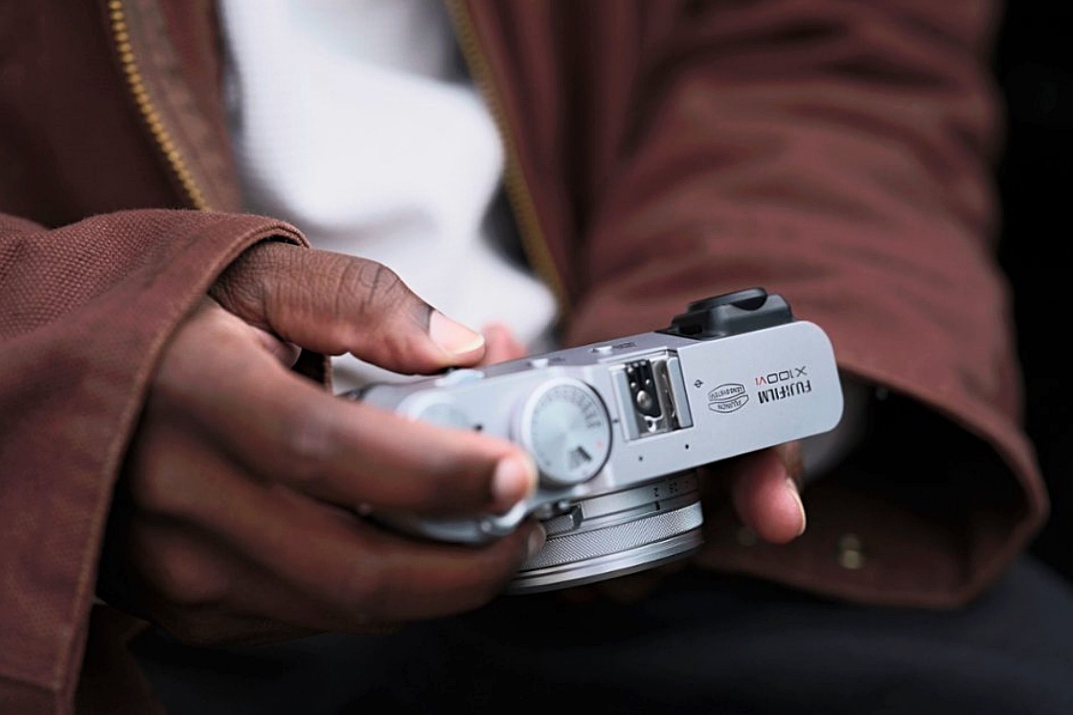 A man holding a Fujifilm X100VI