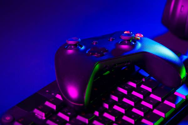 An Xbox wireless controller on top of a keyboard.