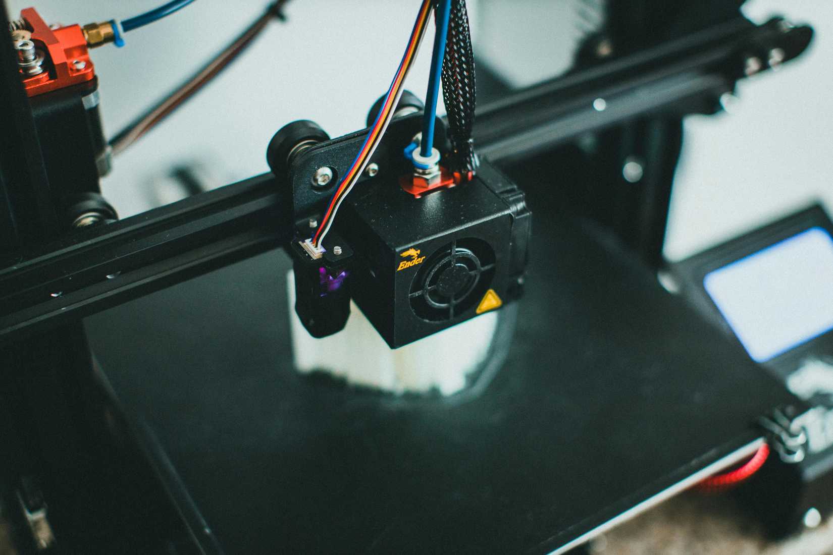 A 3D printer extruder or head.
