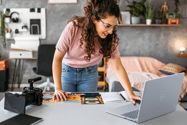 A Young Woman Browsing Pictures on her Dell Notebook