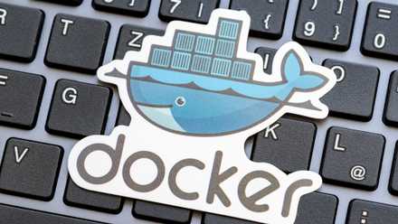 Docker logo placed over a laptop computer keyboard.