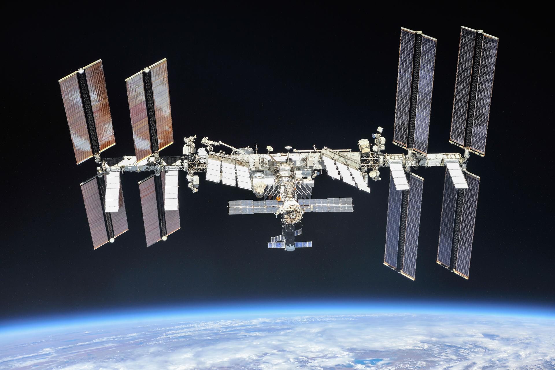 The International Space Station with a distant Earth in the background.