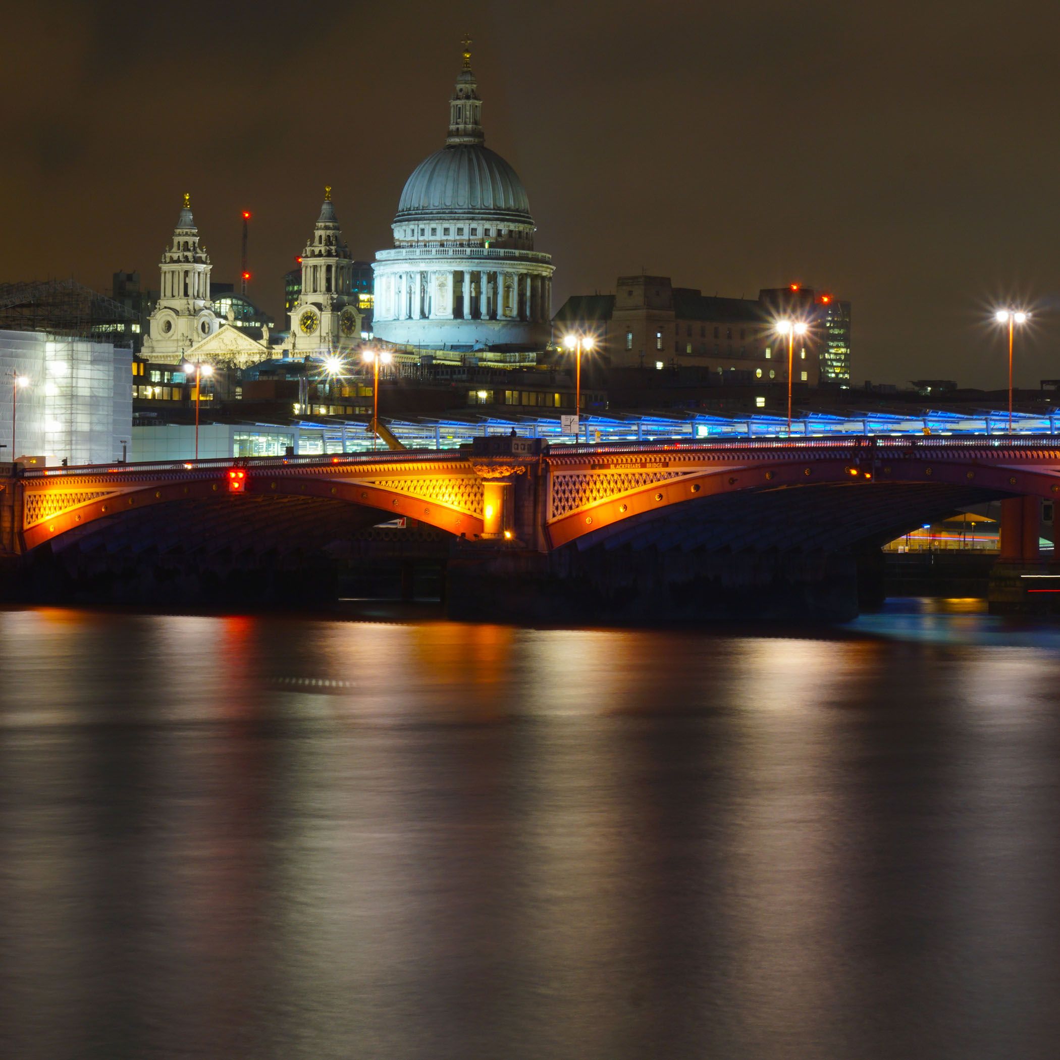 A night shot of St Paul's Cathedral in London, across the Thames.