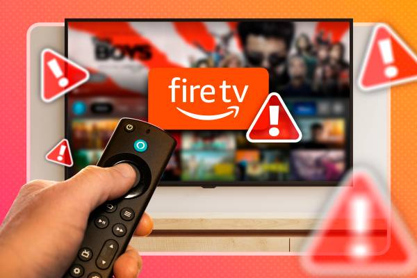 A hand holding a remote in front of a Fire TV with several warning signs around it.