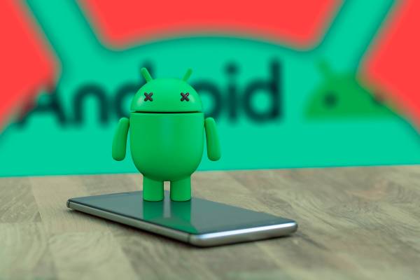 Android mascot on top of a phone with 'X' eyes indicating that it is dead, and the Android logo in the background.