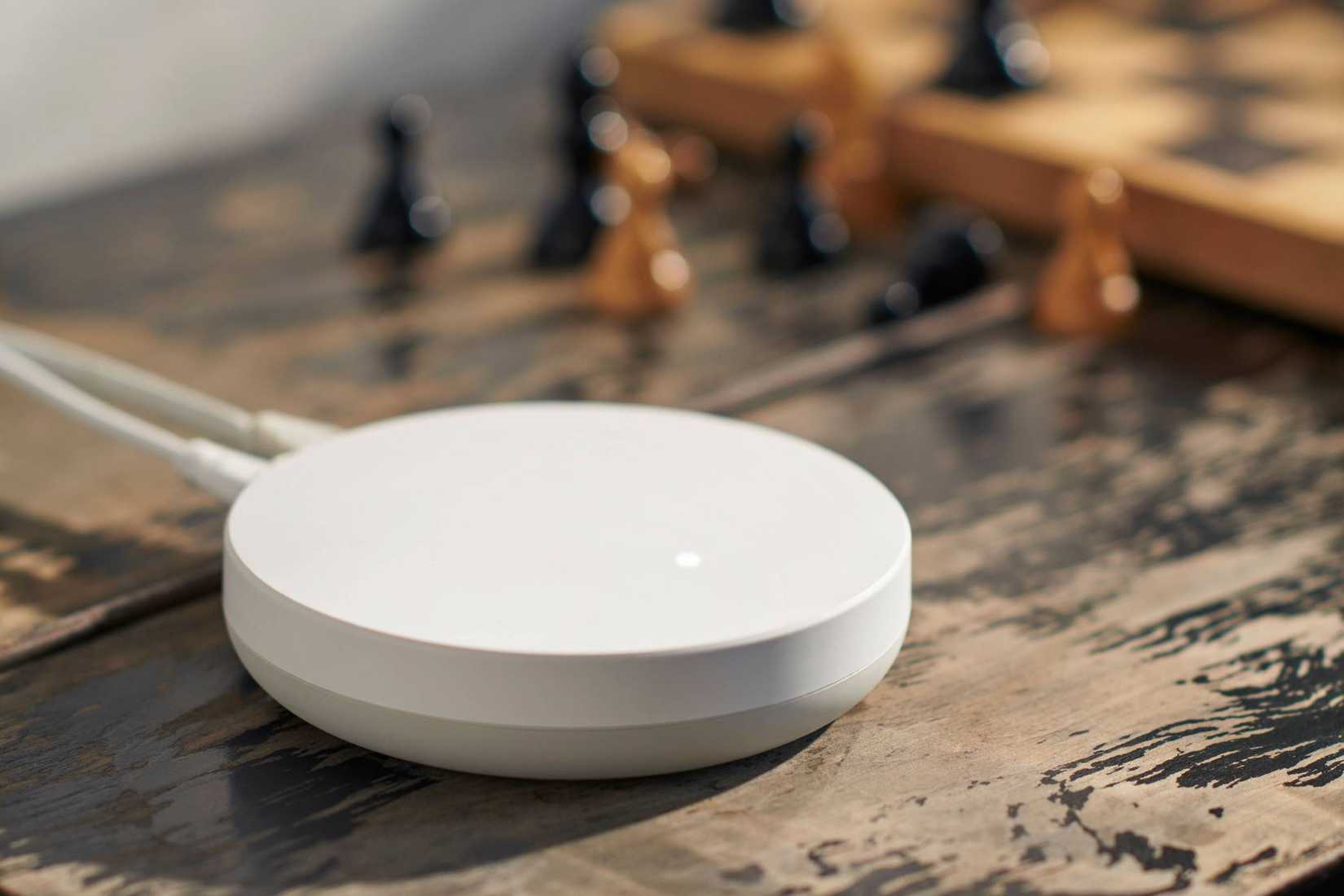 A Dirigera Hub near chess board and pieces.