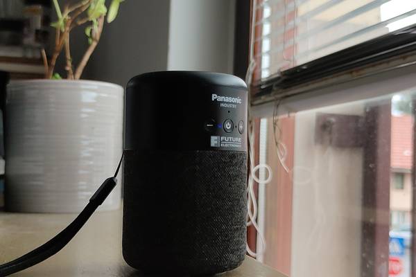 A bluetooth speaker sitting on a desk.