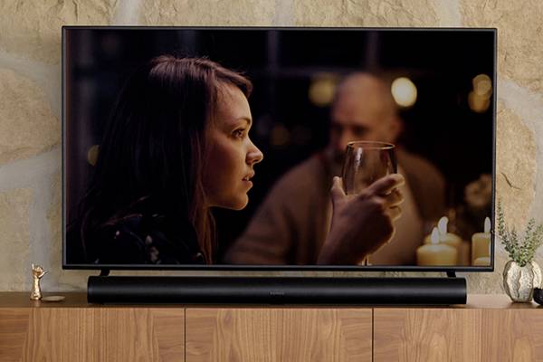 A Sonos Arc placed under a TV.