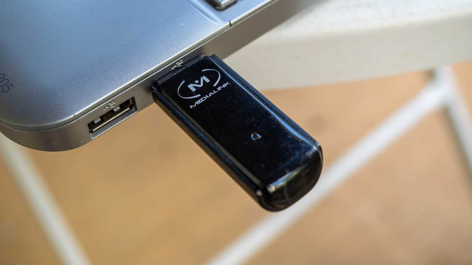 USB Wi-Fi adapter plugged into a laptop.