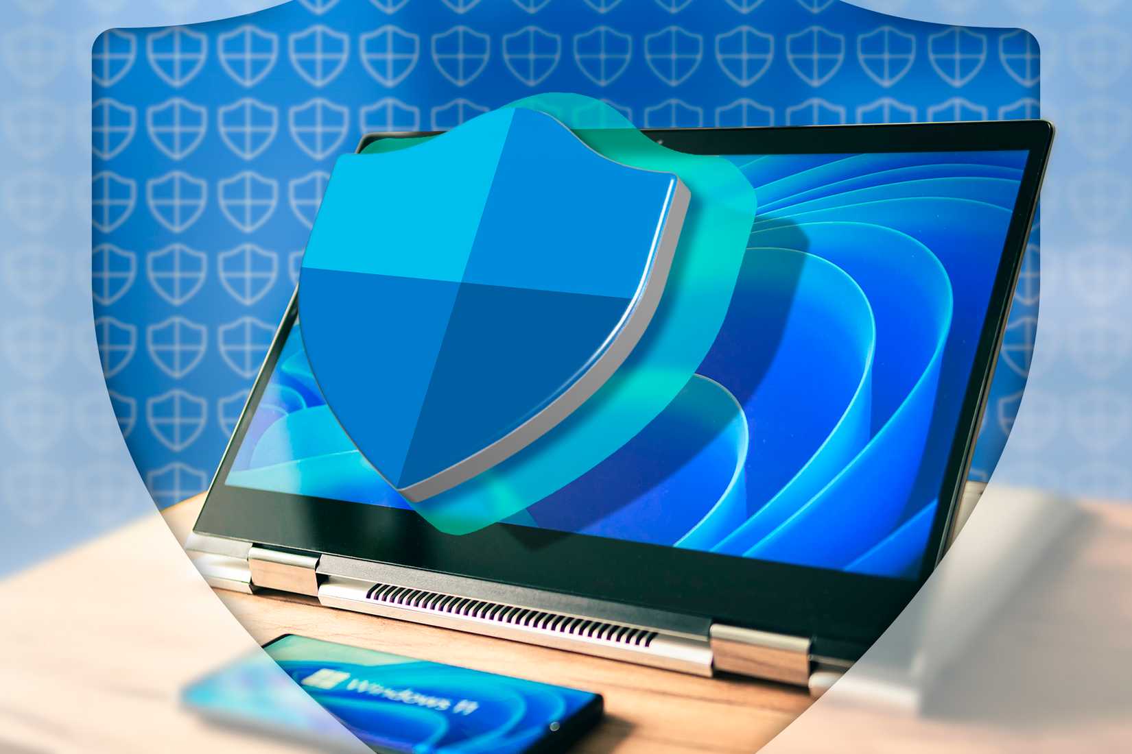 Ноутбук с Windows 11 и логотипом Windows Defender.