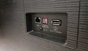 The back of a TV with USB, LAN and optical ports.