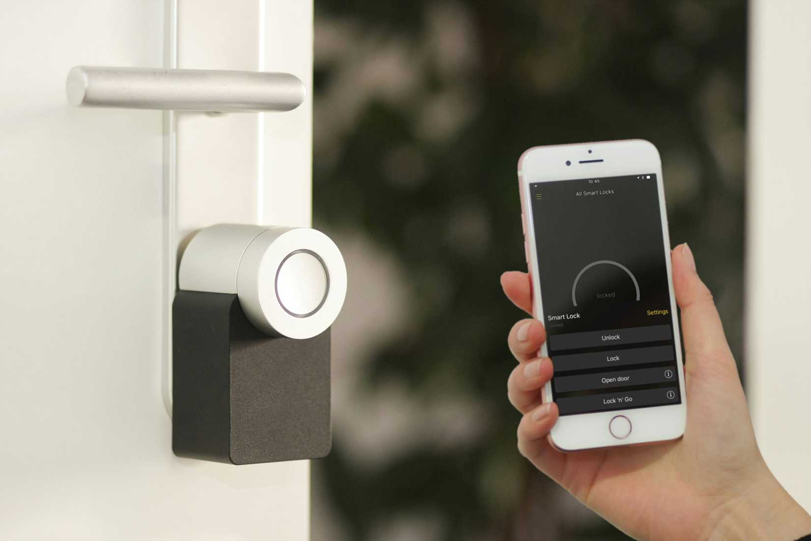 Nuki Smart Lock being opened with a smartphone.