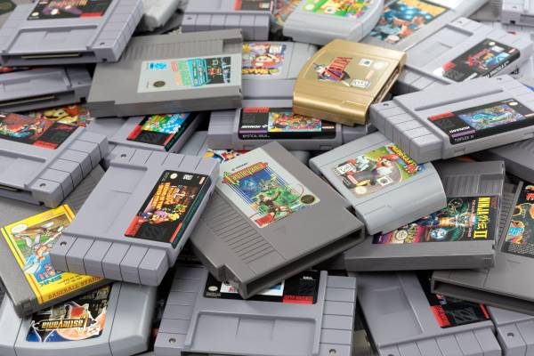 A studio shot of a large pile of Nintendo cartridges.