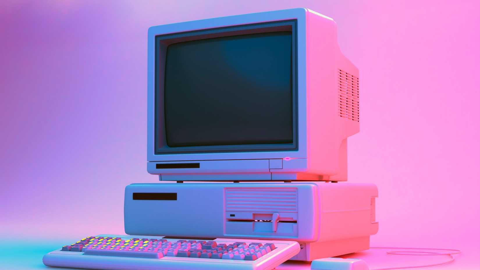 Vintage office PC with floppy player, keyboard and mouse in neon lightning.