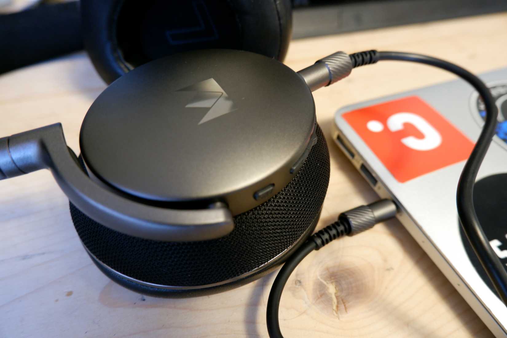 A pair of Noble Fokus Apollo headphones plugged into a Macbook Air.