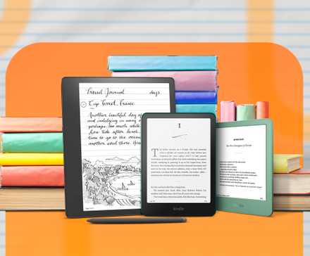 3 different Kindles, side by side, with some books behind them.