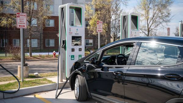 Electrify America power station plugged into and charging a 2023 Chevy Bolt EV.