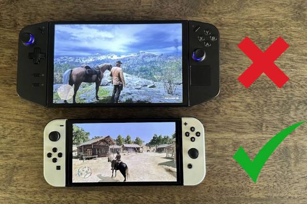 A Lenovo Legion Go and Nintendo Switch OLED running Read Dead Redemption 2 and 1 respectively on a wooden table.