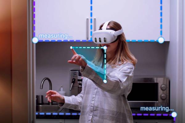 A woman in her home's kitchen using a MetaQuest 3 to take measurements, with some furniture calculating the measurement.