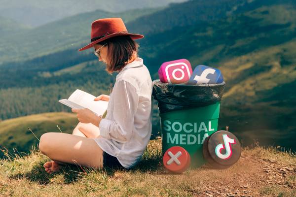 A woman in nature reading a book, with a trash bin behind her containing some social media icons.-1