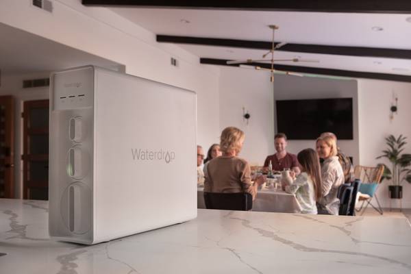 A Family at the Dinner Table With Waterdrop X12 on the Kitchen Counter