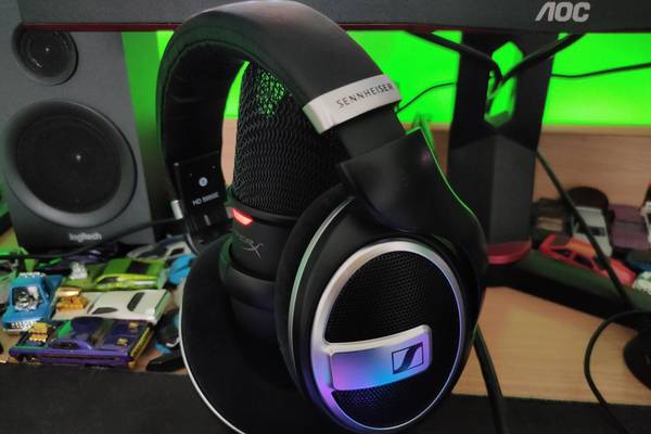 The Sennheiser HD 599 SE headphones sititng on top of a HyperX Solocast microphone.