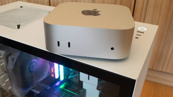 An M4 Mac Mini sitting on top of a PC case. 