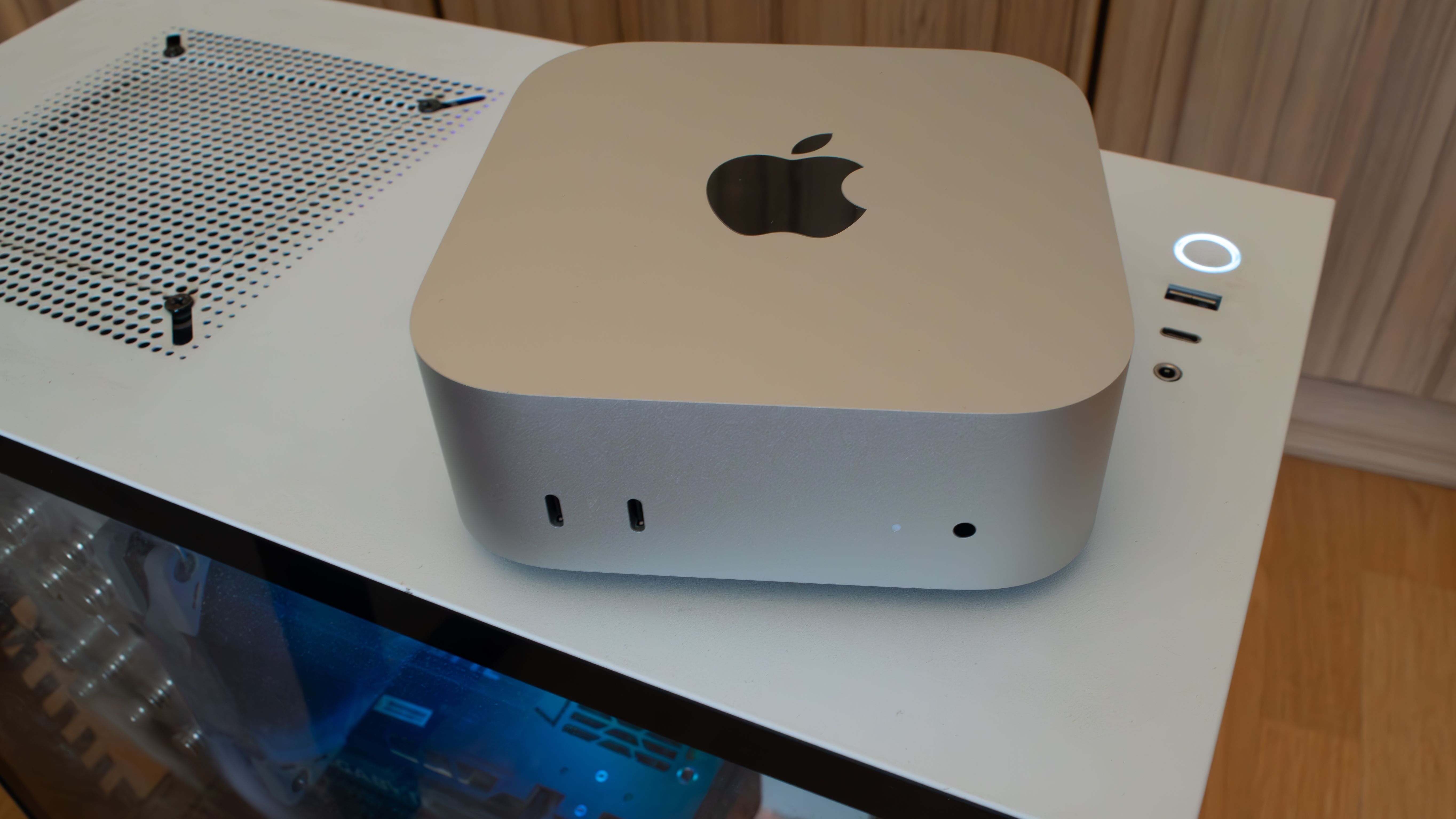 An M4 Mac Mini Sitting on a Windows PC case. 
