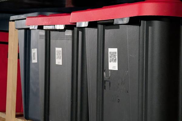 Storage bins with QR code labels.