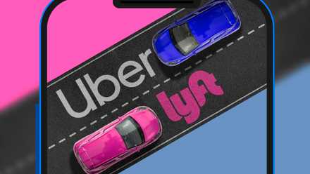 Screen of a phone showing two cars on the road viewed from above, with the Uber and Lyft logos in front of the cars.