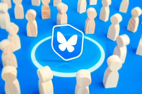 Shield with the Bluesky logo surrounded by a crowd.