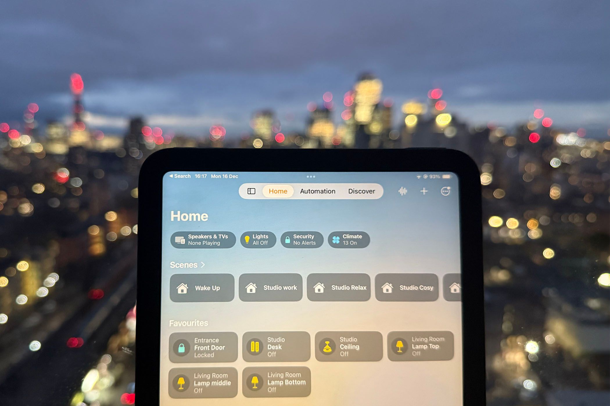 The Home app open on an iPad mini in front of the London skyline.