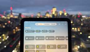 The Home app open on an iPad mini in front of the London skyline.
