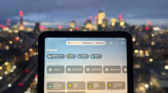 The Home app open on an iPad mini in front of the London skyline.