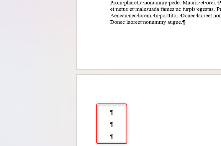 Three paragraph markers at the start of a new page in Microsoft Word.
