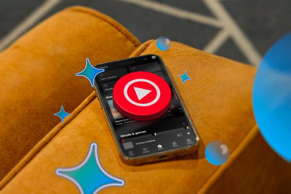 A smartphone on a couch with the YouTube Music logo above the screen. 