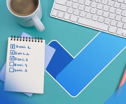 A desk seen from above with a coffee cup, a notepad, a keyboard, and the Microsoft To-Do logo.