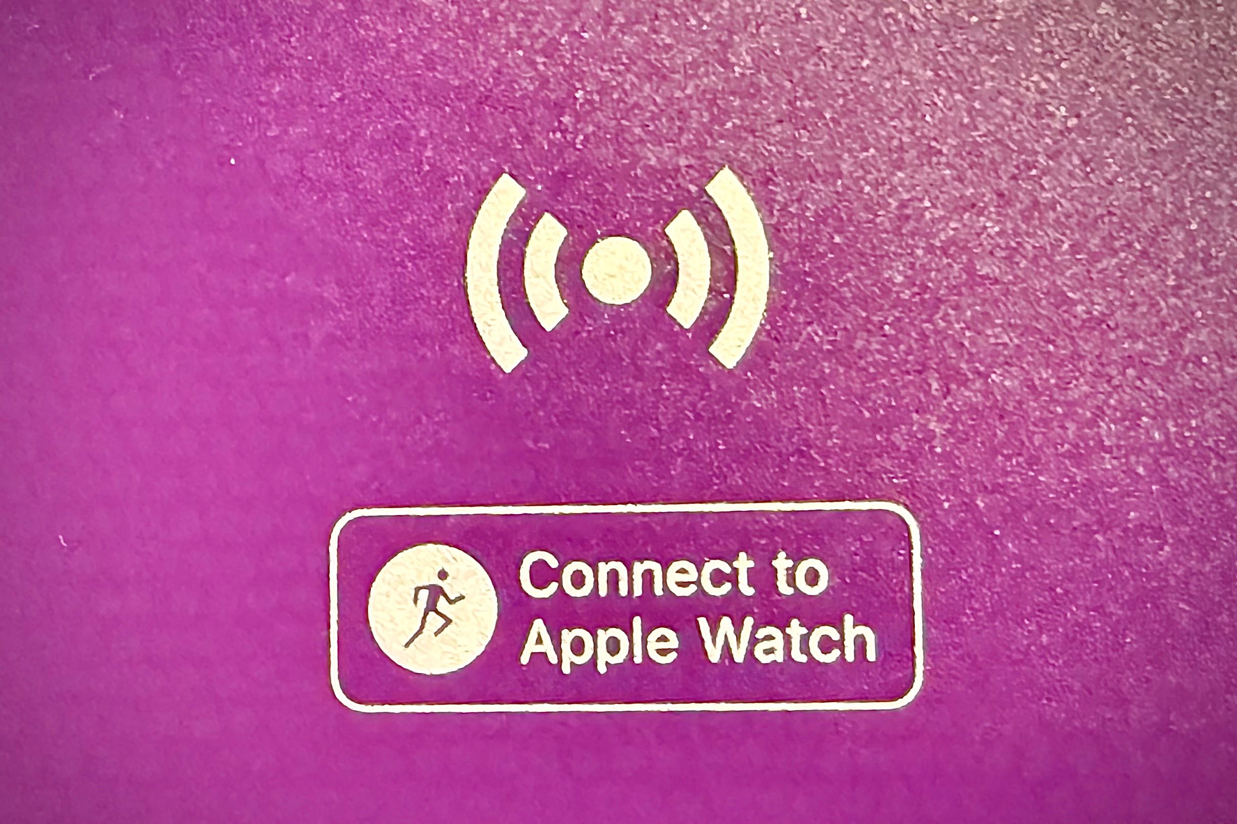 A "Connect to Apple Watch" banner icon on gym equipment to connect your Apple Watch to.