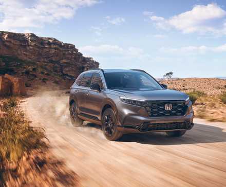 Gray 2024 Honda CR-V Sport off-roading on a dirt track.