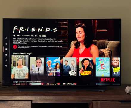 4K TV in a green living room showing Friends and other comfort shows on Netflix.